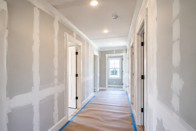 Drywall specialist replacing damaged wall material